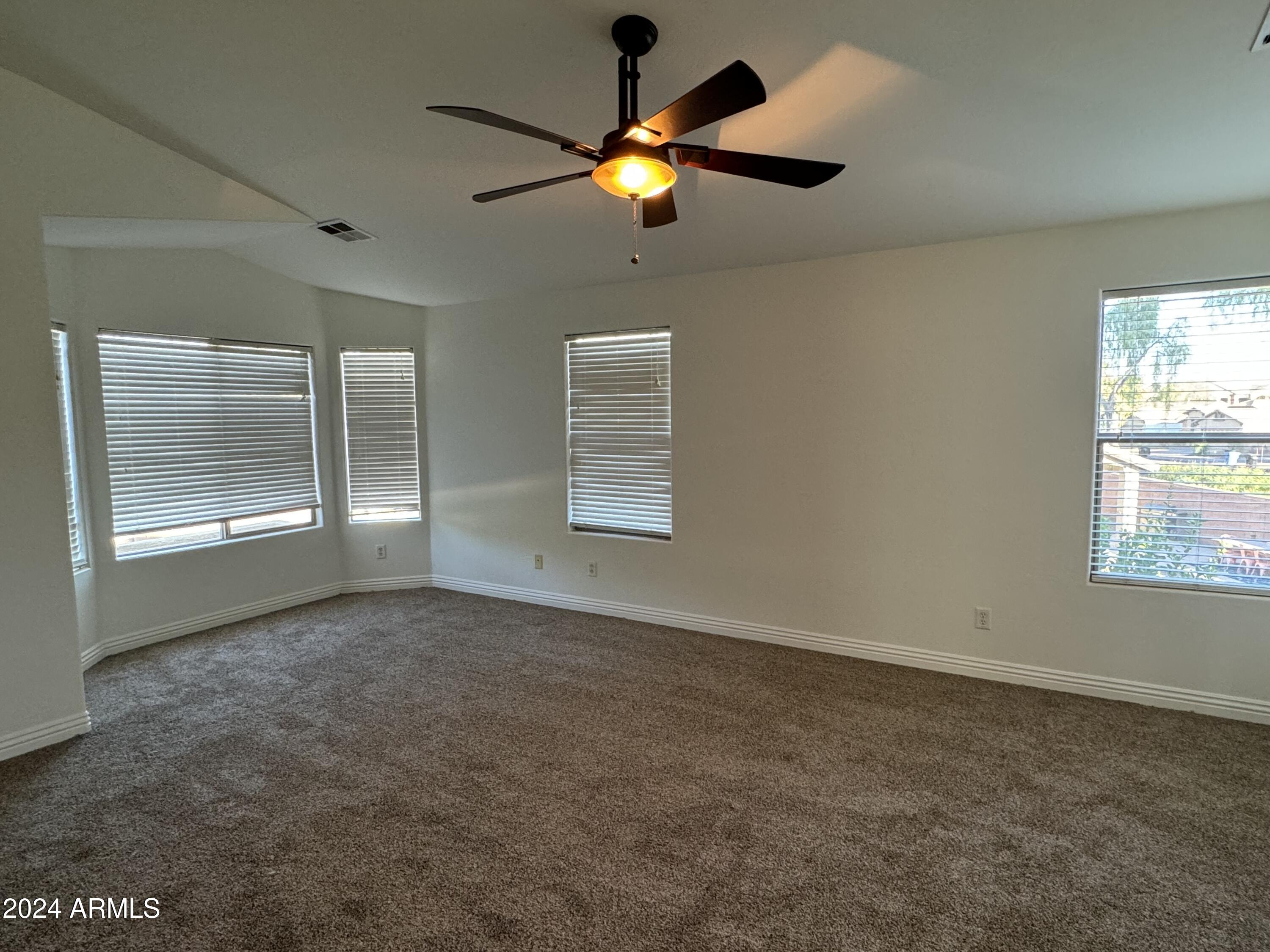 4576 East Sundance Avenue Gilbert, AZ 85297 - Photo 11 of 23 an empty room with windows and fan