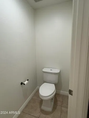 a white toilet sitting next to a shower