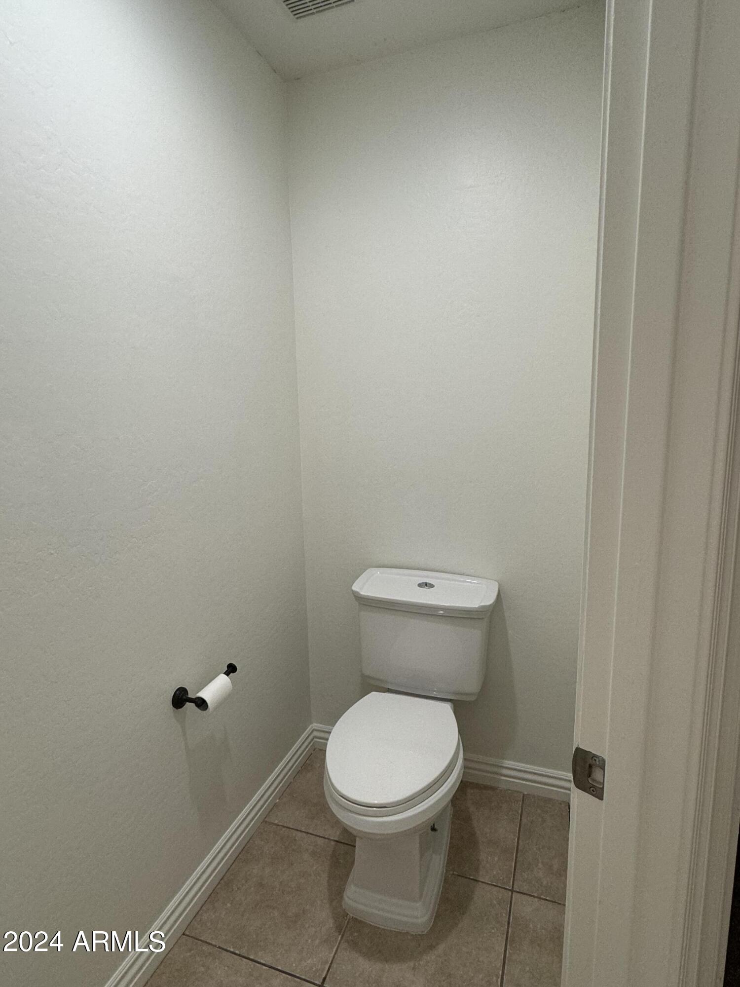 4576 East Sundance Avenue Gilbert, AZ 85297 - Photo 14 of 23 a white toilet sitting next to a shower