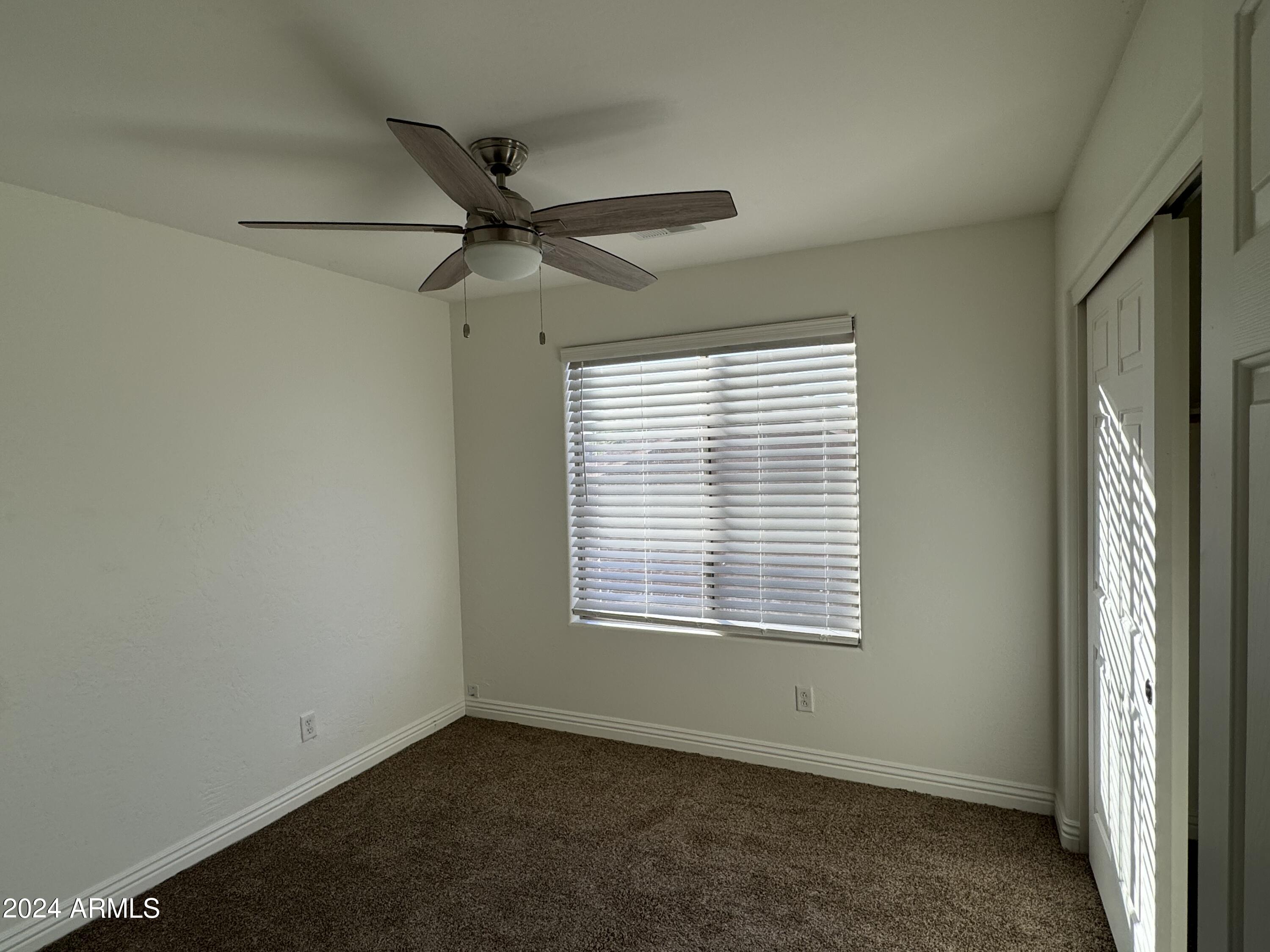 4576 East Sundance Avenue Gilbert, AZ 85297 - Photo 18 of 23 an empty room with a window and a fan