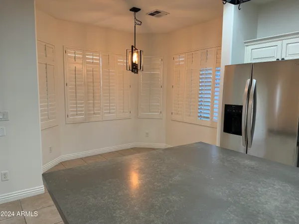 a view of a kitchen with a sink and refrigerator