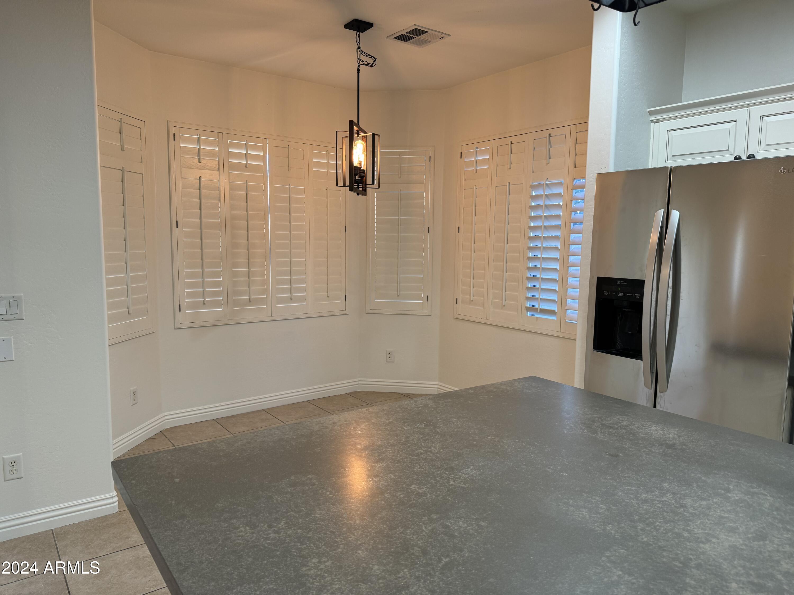 4576 East Sundance Avenue Gilbert, AZ 85297 - Photo 6 of 23 a view of a kitchen with a sink and refrigerator