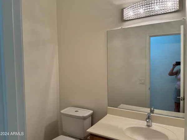 a bathroom with a sink a toilet and mirror
