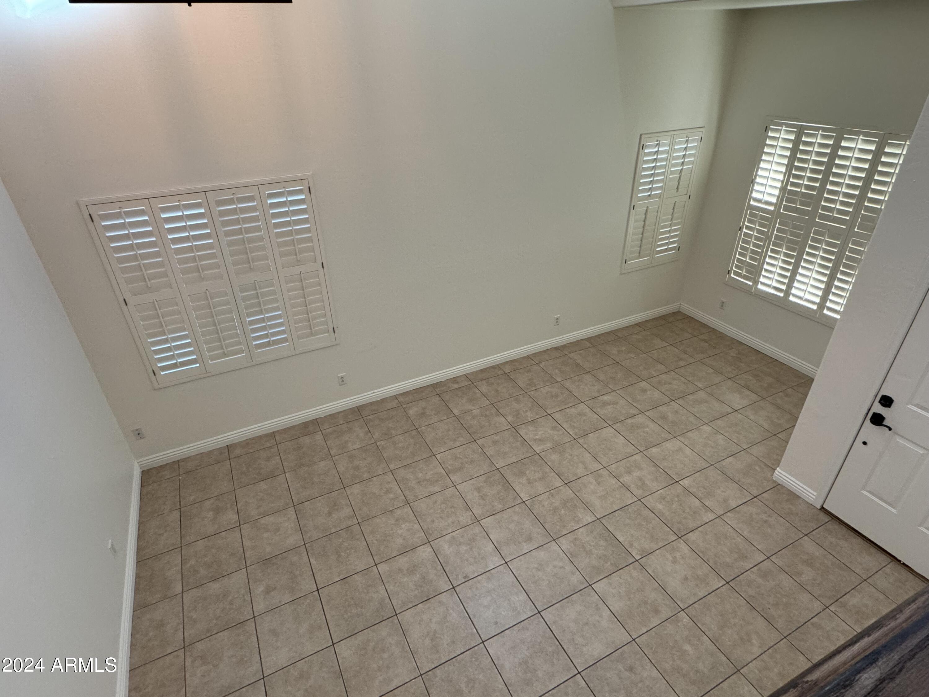 4576 East Sundance Avenue Gilbert, AZ 85297 - Photo 9 of 23 an empty room with windows