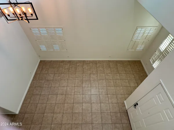 a view of an empty room and staircase