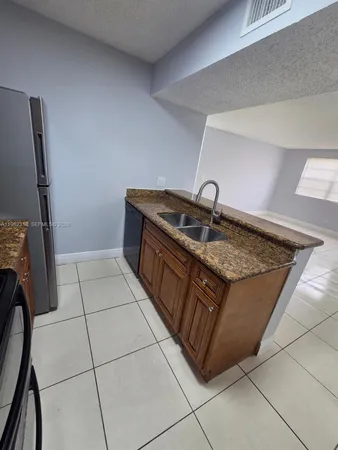 a kitchen with a sink a refrigerator and washer