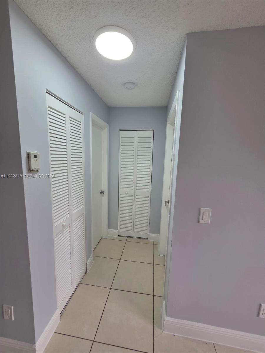 1241 Southwest 46th Avenue, Unit 1006 Pompano Beach, FL 33069 - Photo 3 of 9 a view of an empty room with a window