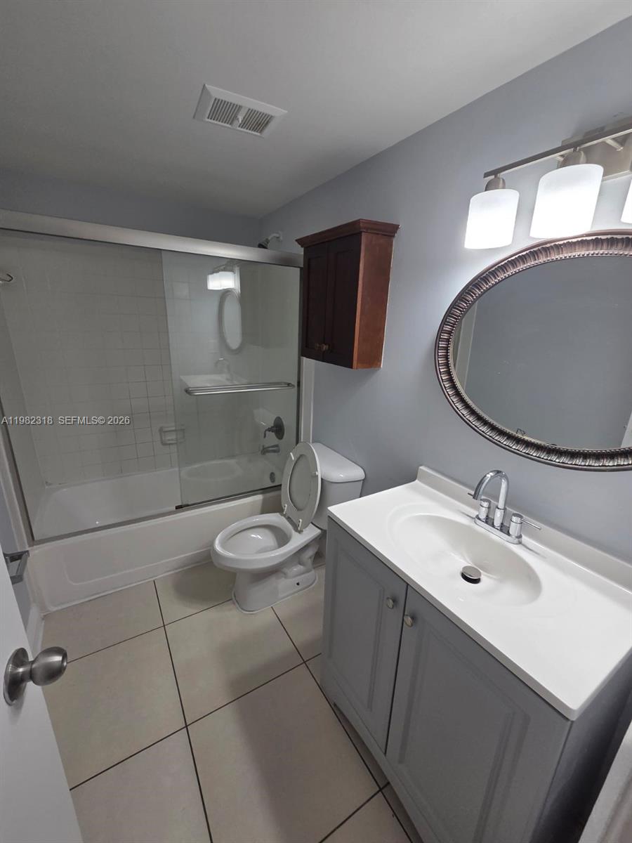 1241 Southwest 46th Avenue, Unit 1006 Pompano Beach, FL 33069 - Photo 9 of 9 a bathroom with a sink and a mirror