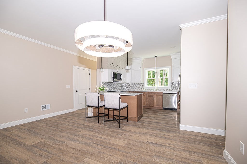 10 Meadowview Lane, Unit B Salisbury, MA 01952 - Photo 17 of 31 a kitchen with a refrigerator and stools