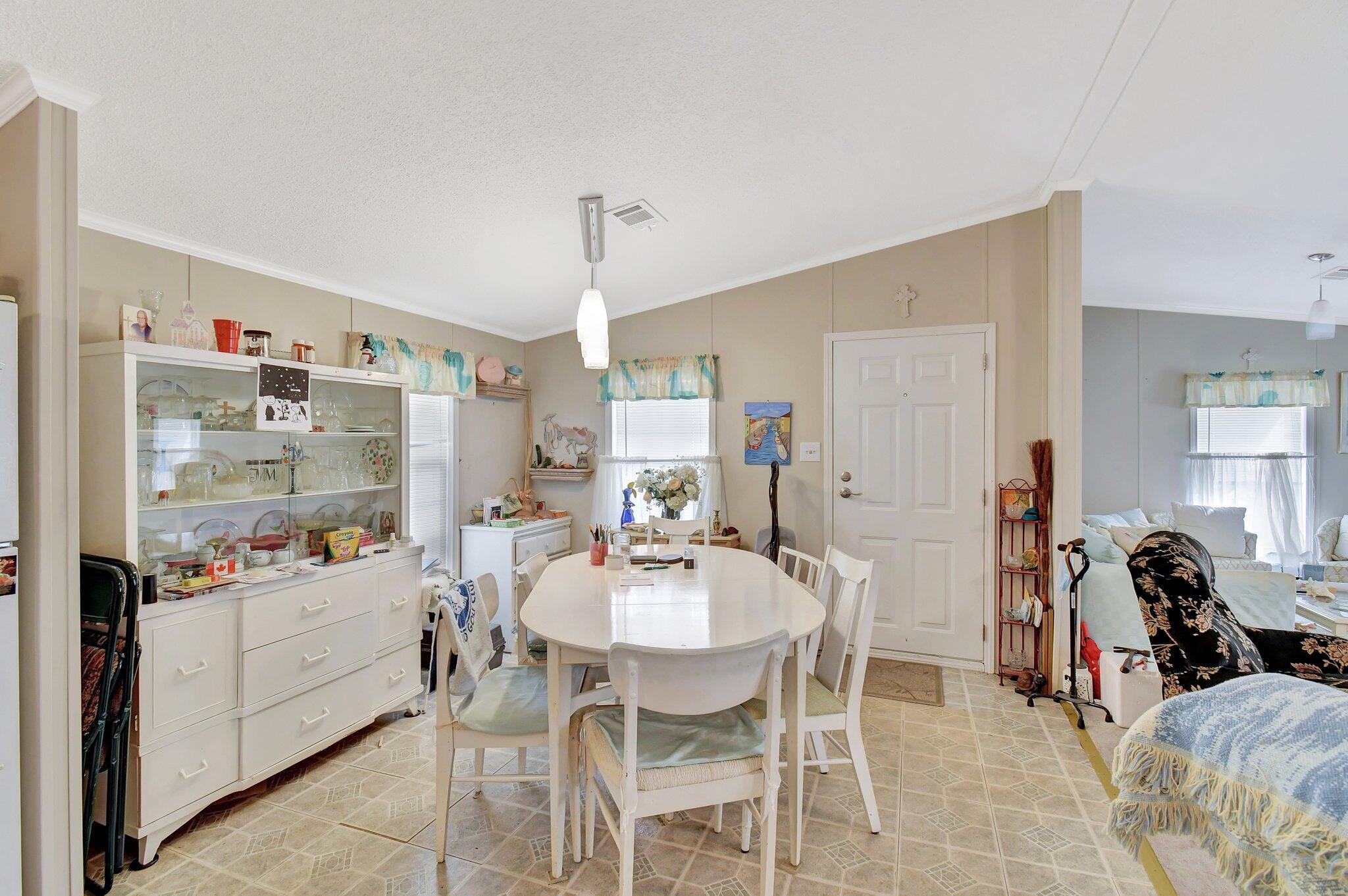 14567 Sunset Drive Delray Beach, FL 33445 - Photo 16 of 32 a dining room with furniture and window
