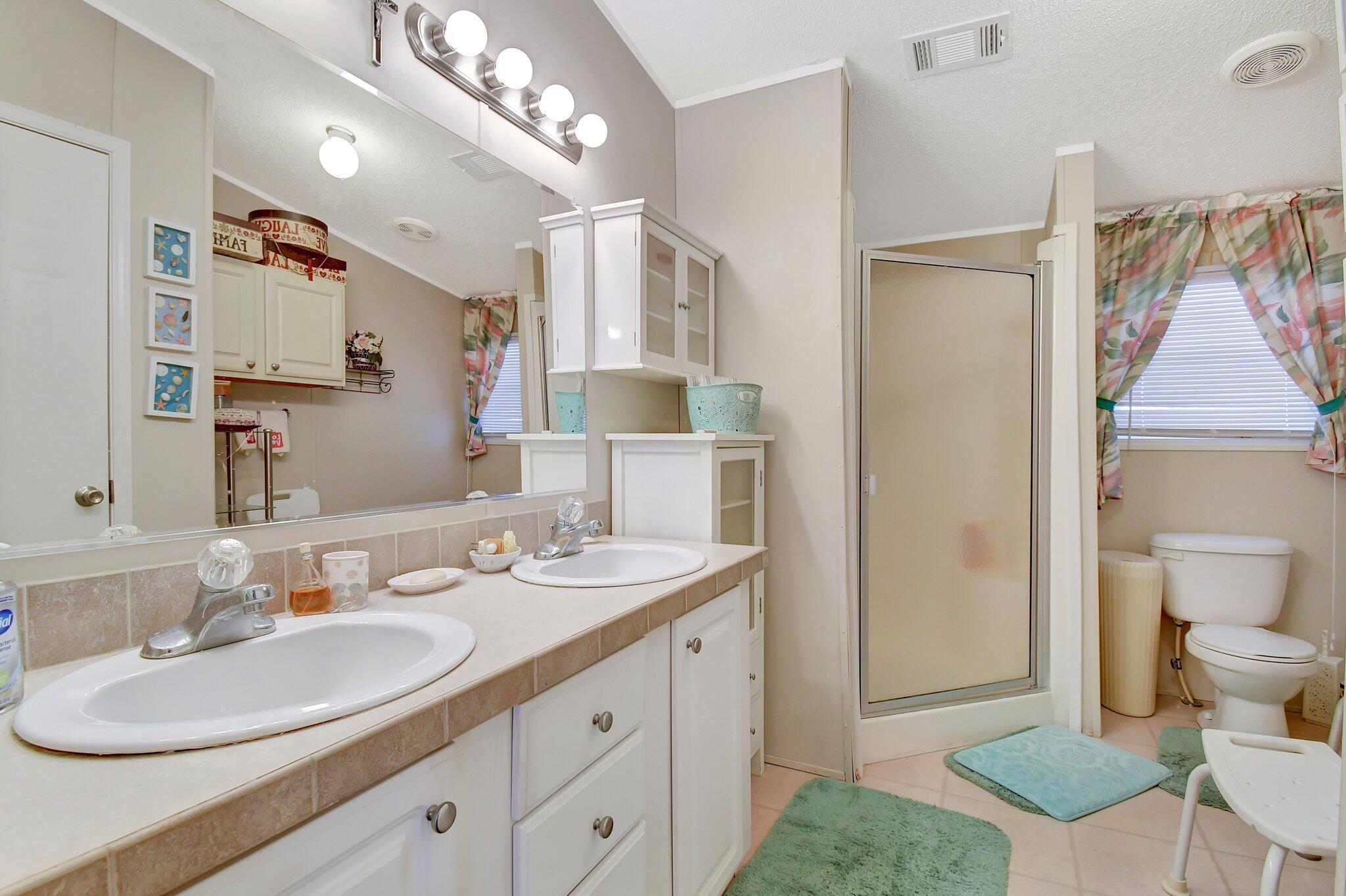14567 Sunset Drive Delray Beach, FL 33445 - Photo 19 of 32 a bathroom with a sink double vanity and a mirror