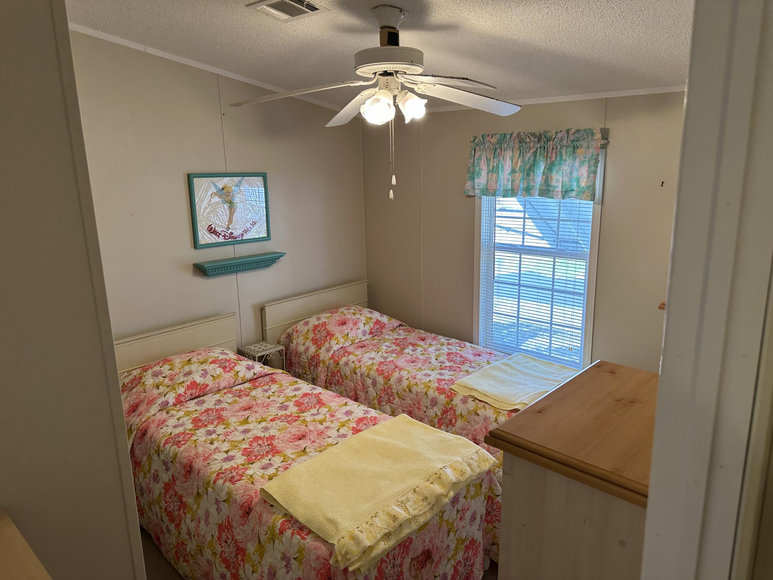 14567 Sunset Drive Delray Beach, FL 33445 - Photo 20 of 32 a bedroom with a bed and a chandelier