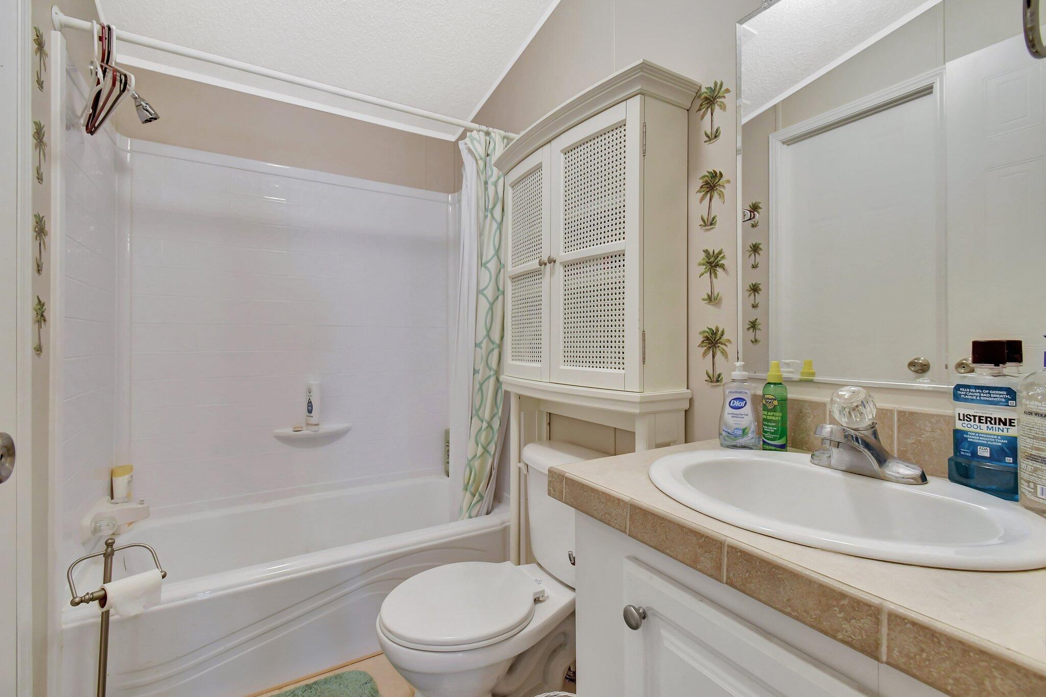 14567 Sunset Drive Delray Beach, FL 33445 - Photo 22 of 32 a bathroom with a sink toilet and shower
