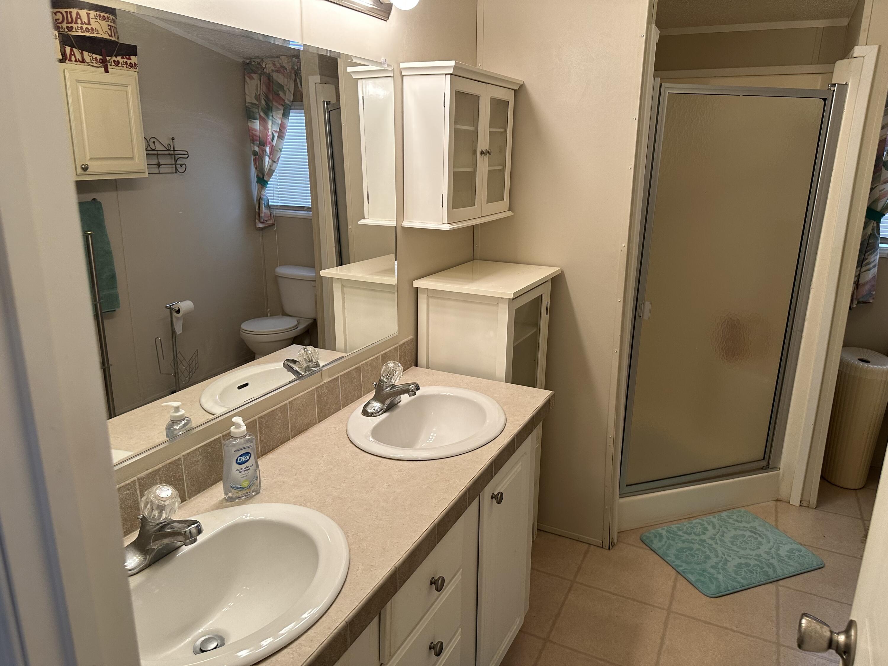 14567 Sunset Drive Delray Beach, FL 33445 - Photo 28 of 32 a bathroom with a sink toilet and mirror