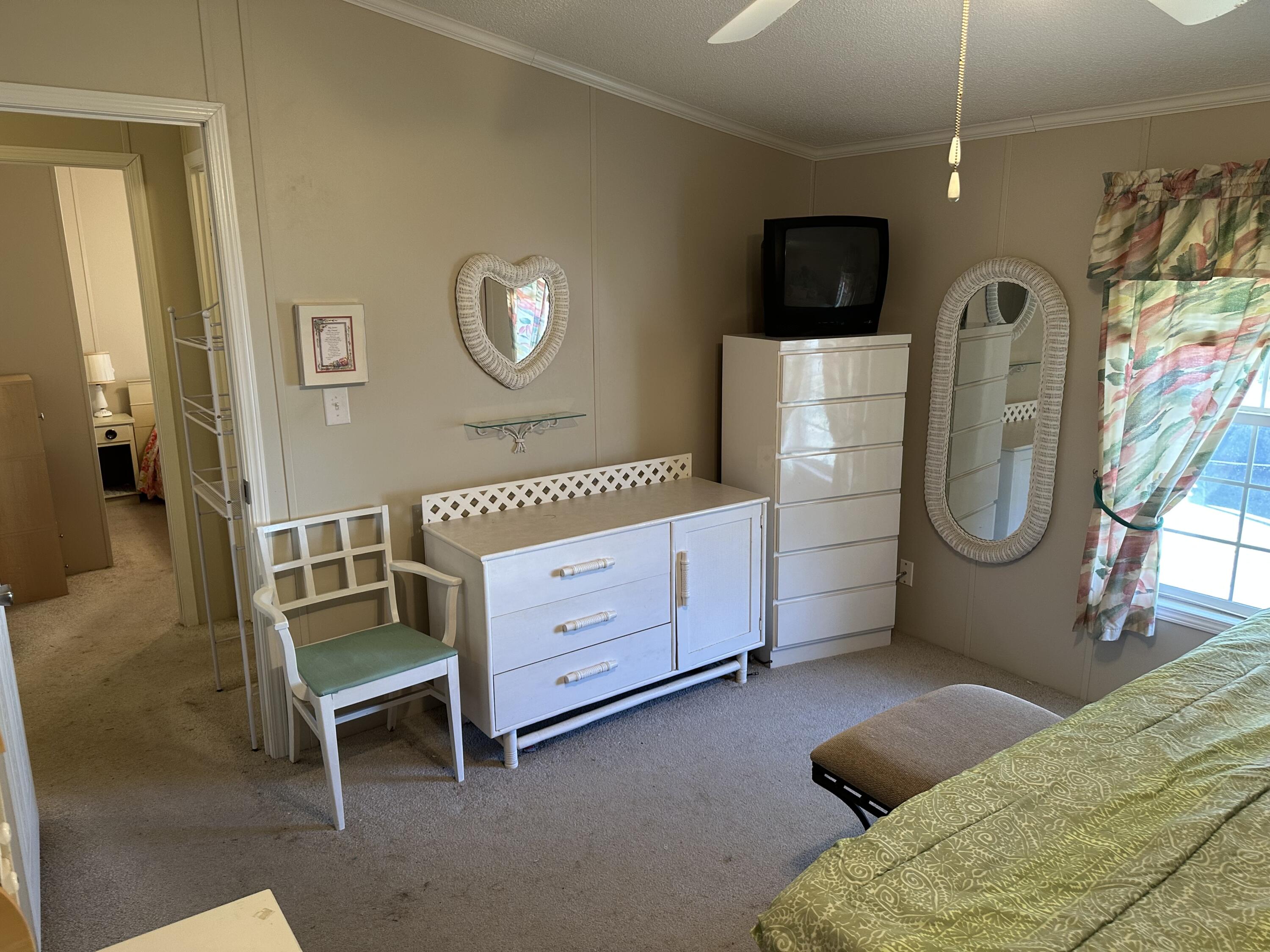 14567 Sunset Drive Delray Beach, FL 33445 - Photo 30 of 32 a bedroom with furniture and a flat screen tv