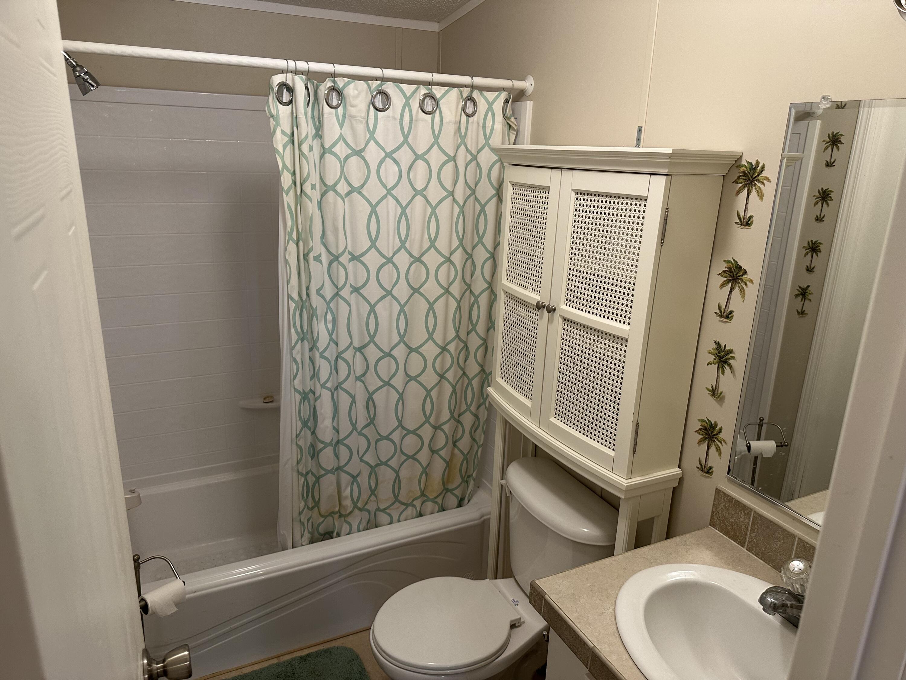 14567 Sunset Drive Delray Beach, FL 33445 - Photo 31 of 32 a bathroom with a toilet and shower
