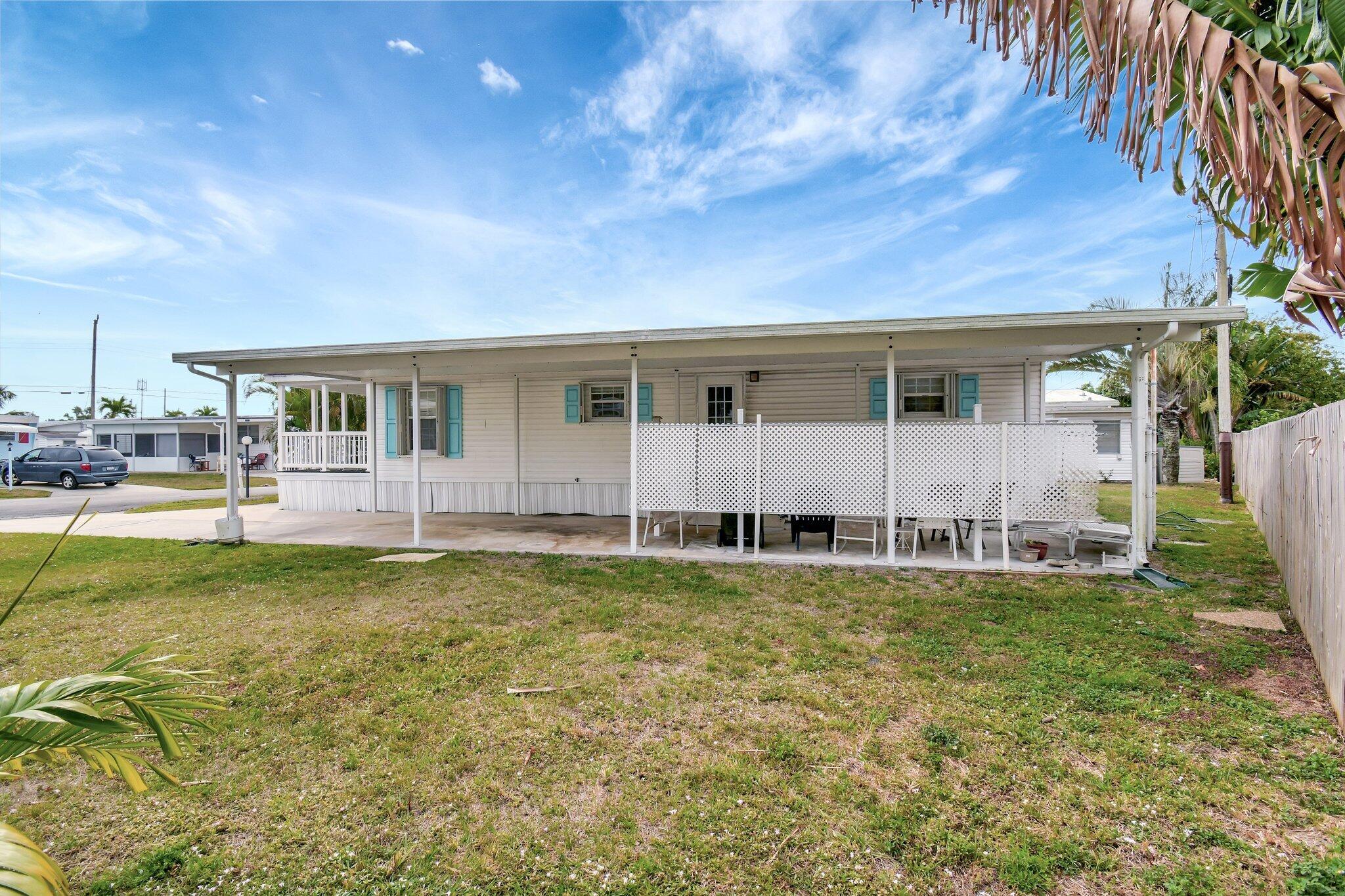 14567 Sunset Drive Delray Beach, FL 33445 - Photo 6 of 32 a view of a house with a swimming pool and a yard