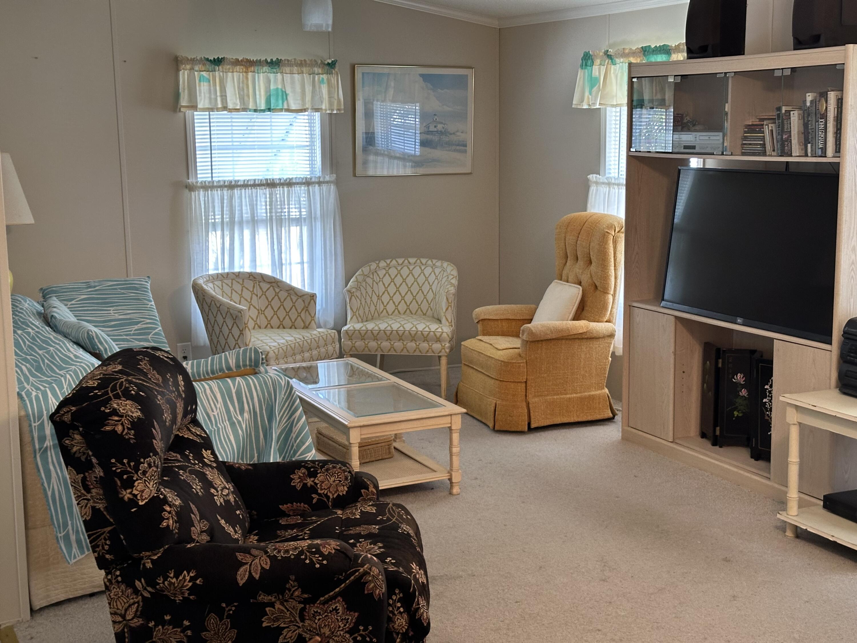 14567 Sunset Drive Delray Beach, FL 33445 - Photo 8 of 32 a living room with furniture and a flat screen tv
