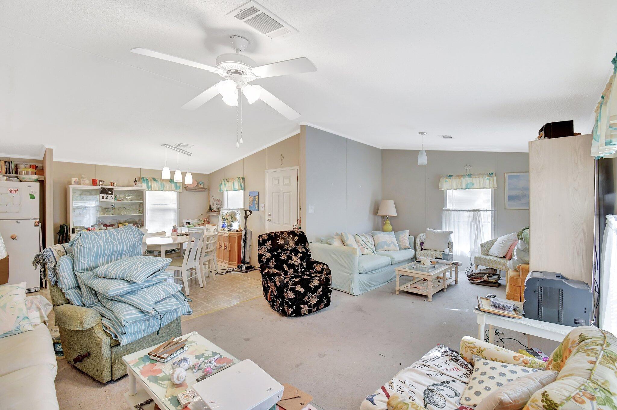 14567 Sunset Drive Delray Beach, FL 33445 - Photo 10 of 32 a living room with furniture and a chandelier