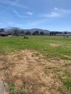 a view of a big yard with table and chair