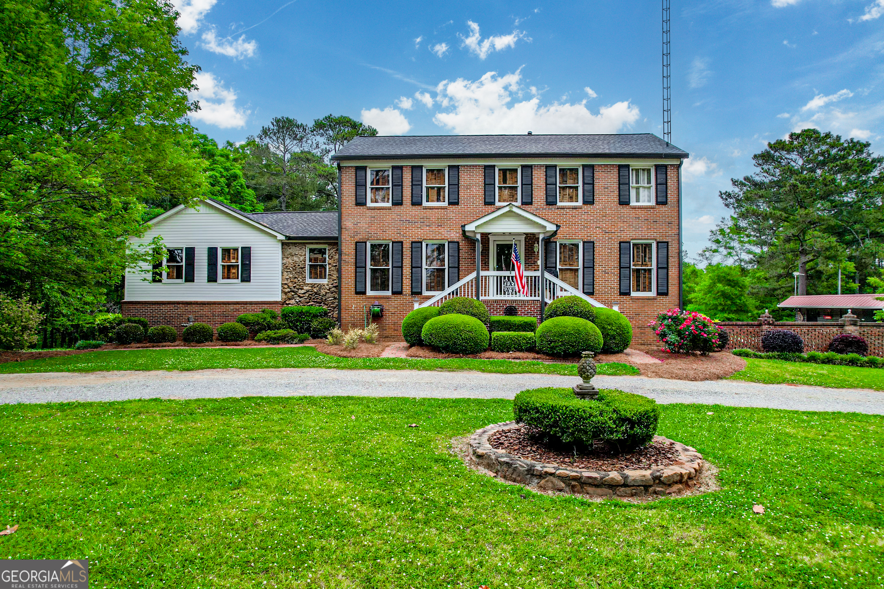 928 Madison Road Eatonton, GA 31024 - Photo 1 of 1 a front view of a house with a yard and potted plants