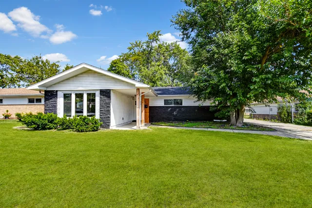 a front view of a house with a garden