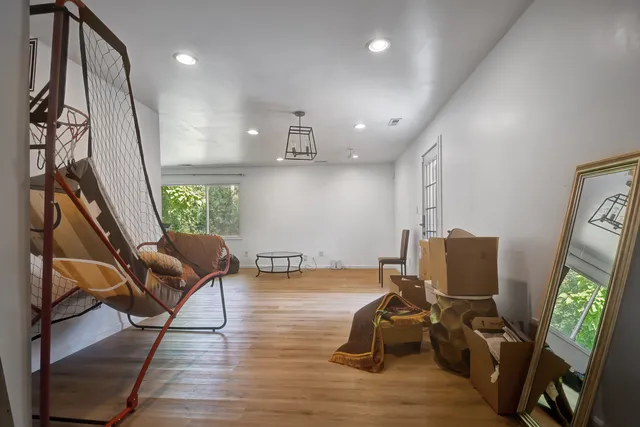 a view of a workspace with furniture and a window