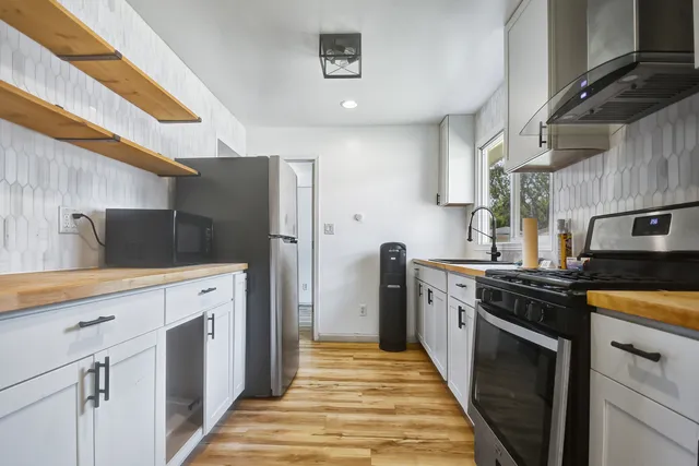 a kitchen with stainless steel appliances a stove and a refrigerator