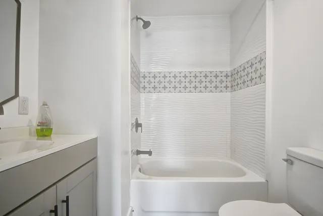 a bathroom with a bathtub and a sink