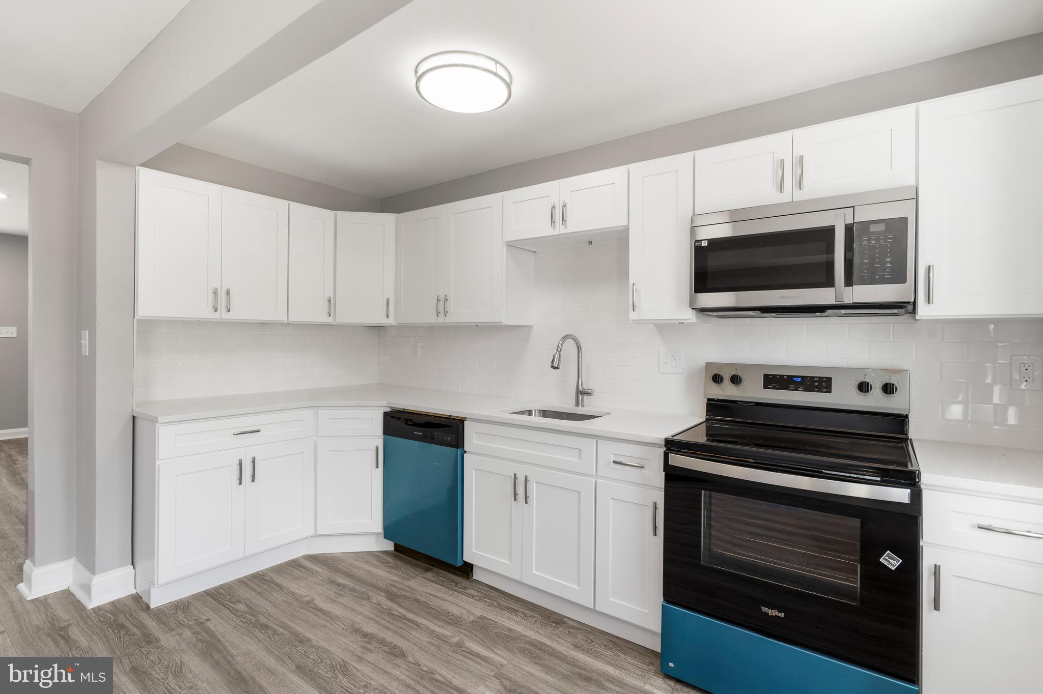 1263 Neighbors Avenue Baltimore, MD 21237 - Photo 11 of 33 a kitchen with cabinets stainless steel appliances and a counter space