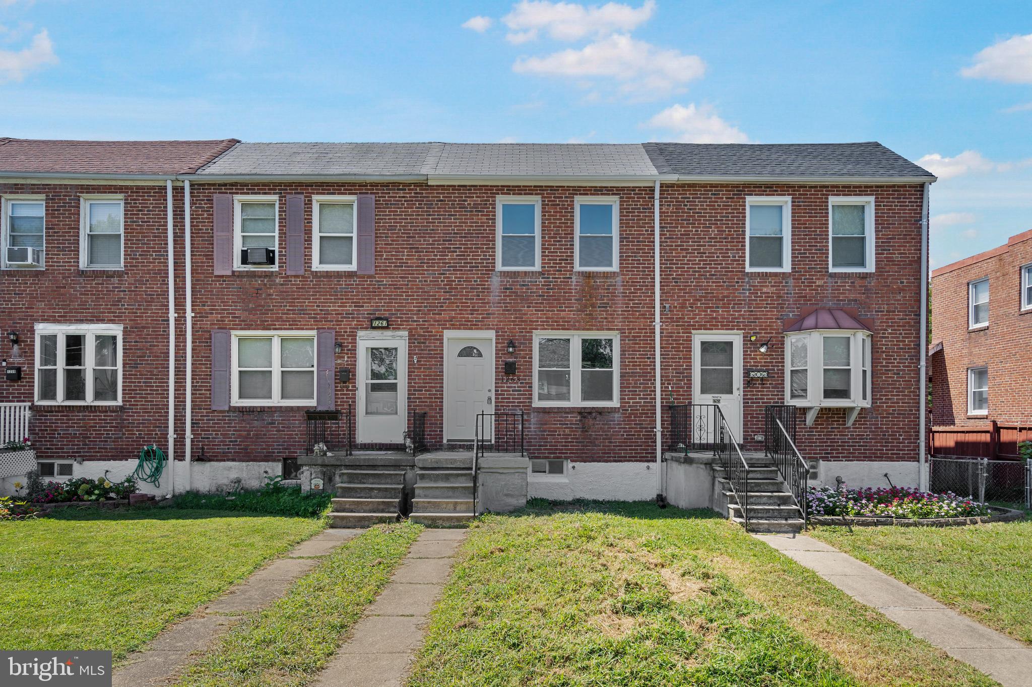 1263 Neighbors Avenue Baltimore, MD 21237 - Photo 2 of 33 a front view of a house with a yard