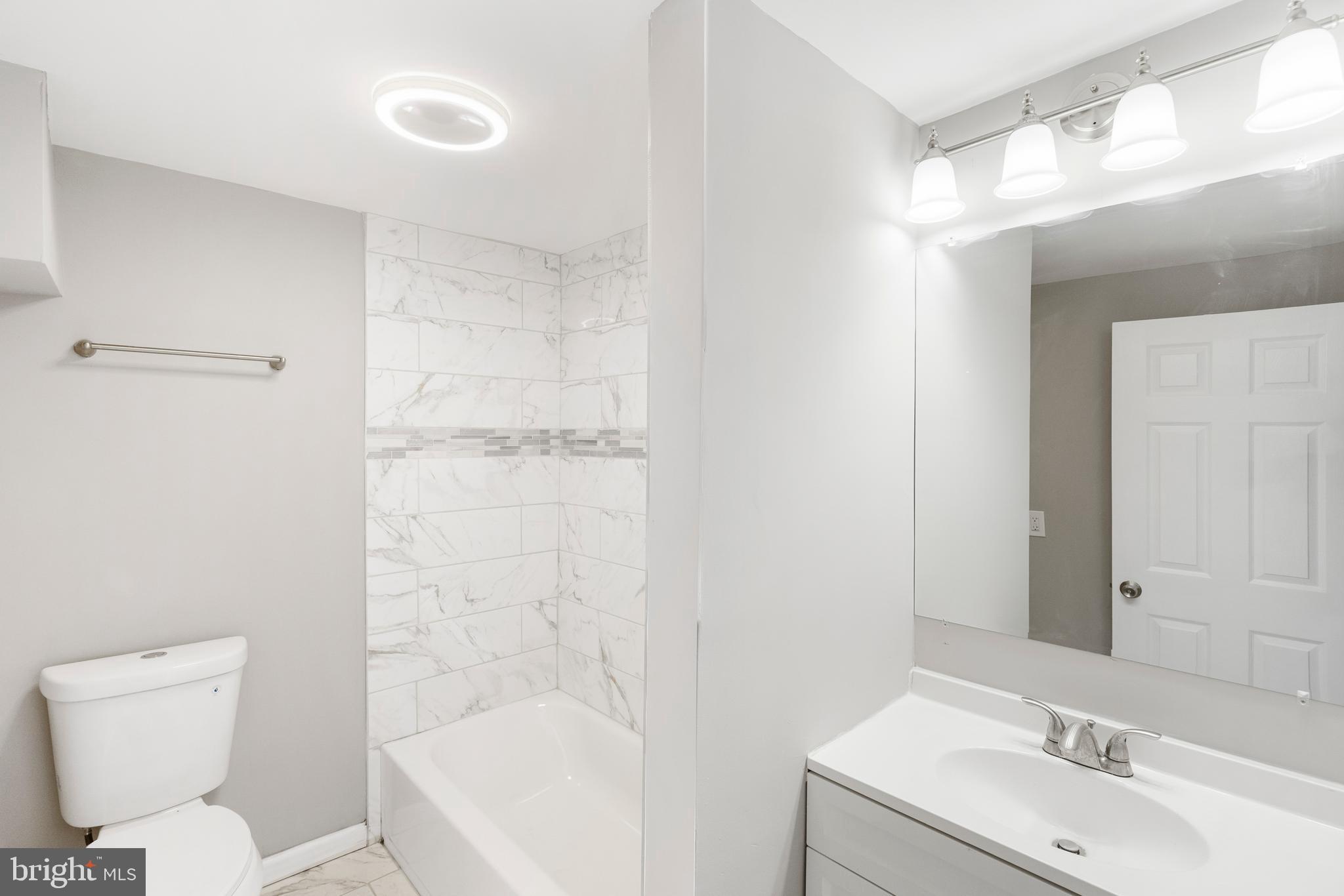 1263 Neighbors Avenue Baltimore, MD 21237 - Photo 21 of 33 a bathroom with a sink toilet and shower