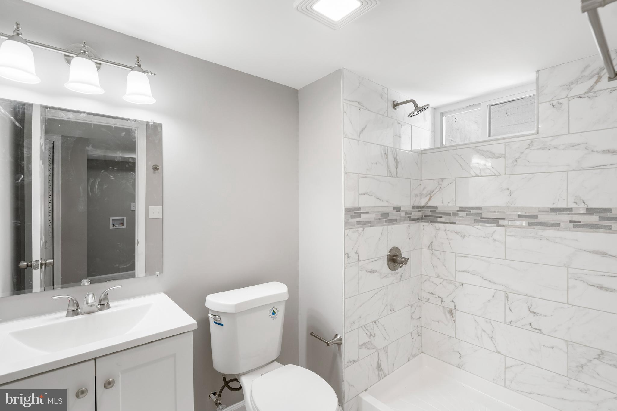 1263 Neighbors Avenue Baltimore, MD 21237 - Photo 27 of 33 a bathroom with a granite countertop sink mirror vanity and toilet
