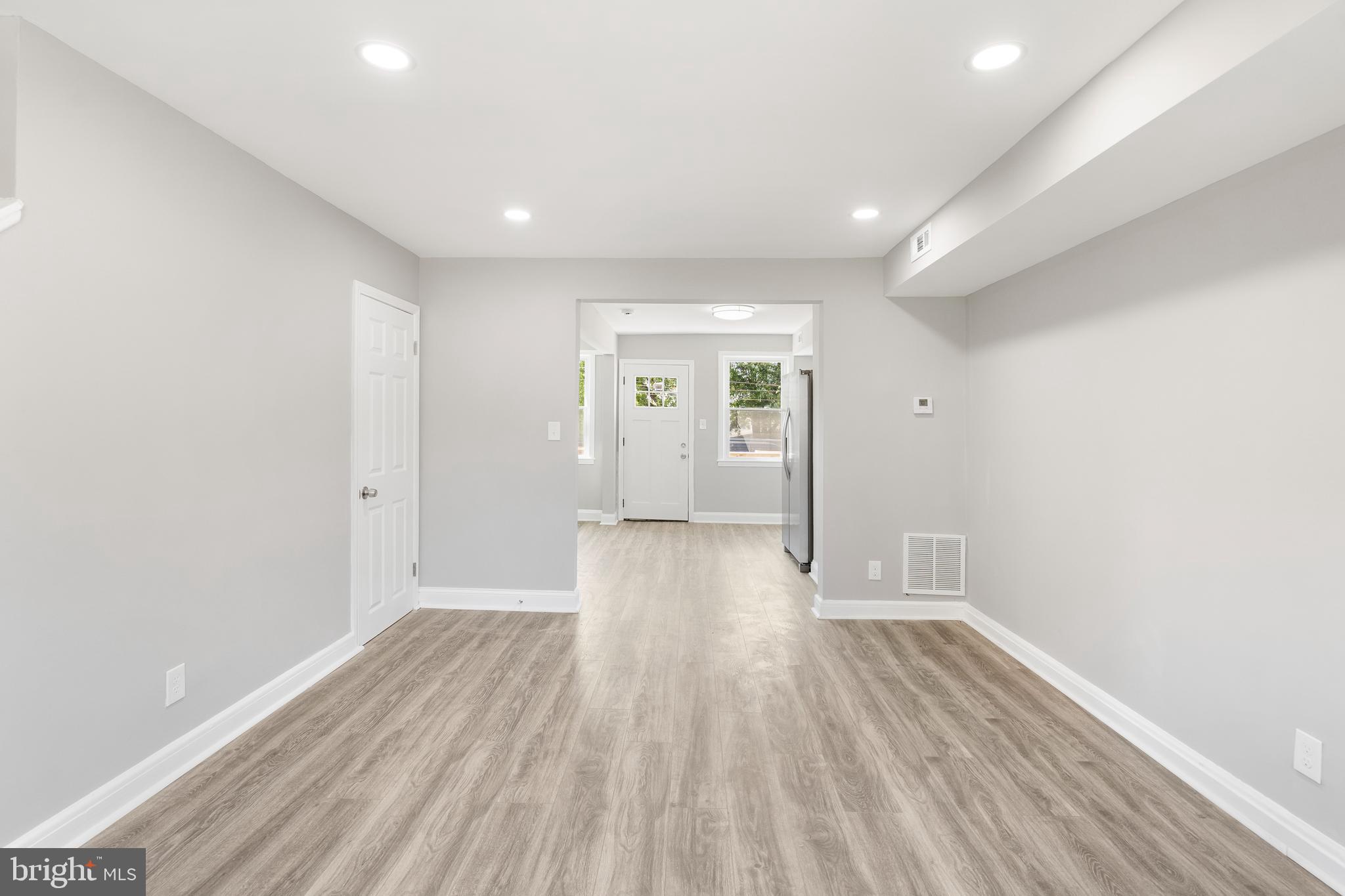 1263 Neighbors Avenue Baltimore, MD 21237 - Photo 5 of 33 a view of a big room with wooden floor and windows