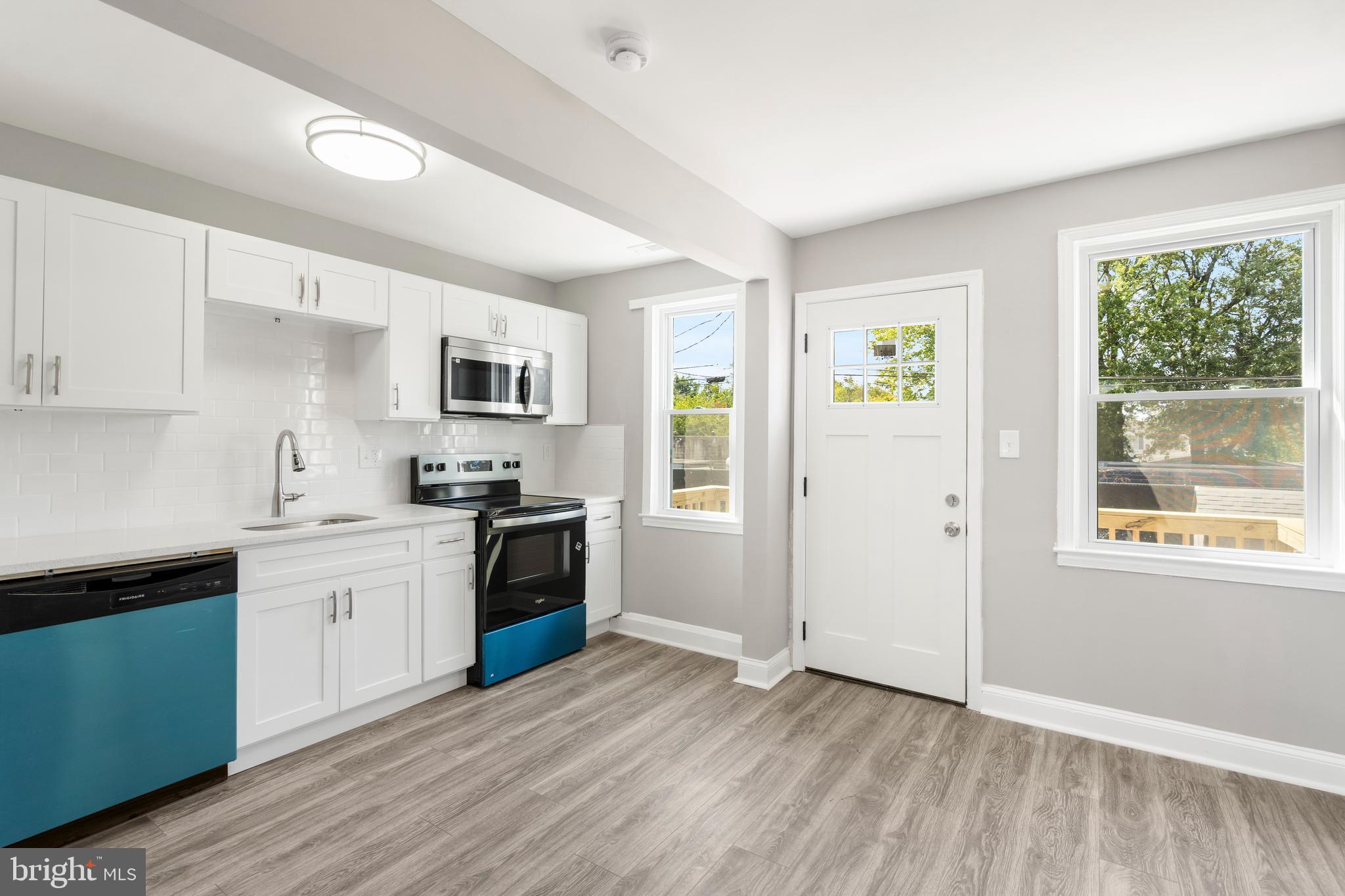 1263 Neighbors Avenue Baltimore, MD 21237 - Photo 8 of 33 a kitchen with a refrigerator and a stove top oven