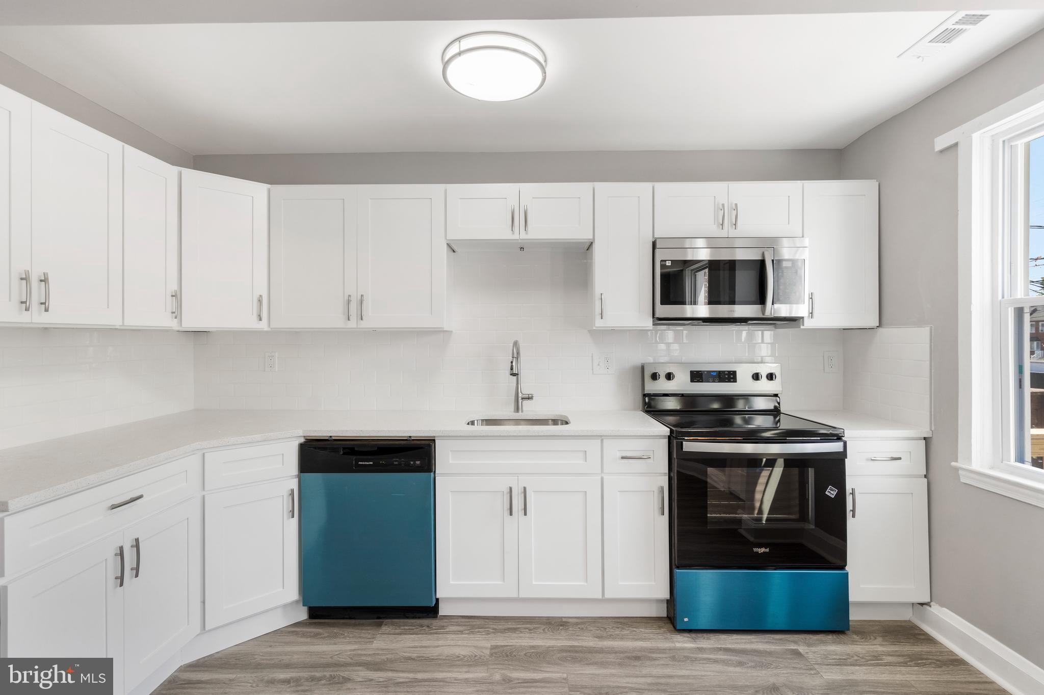 1263 Neighbors Avenue Baltimore, MD 21237 - Photo 10 of 33 a kitchen with stainless steel appliances granite countertop a stove a sink and a microwave