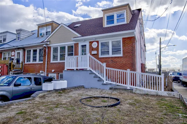 a front view of a house with garden and patio