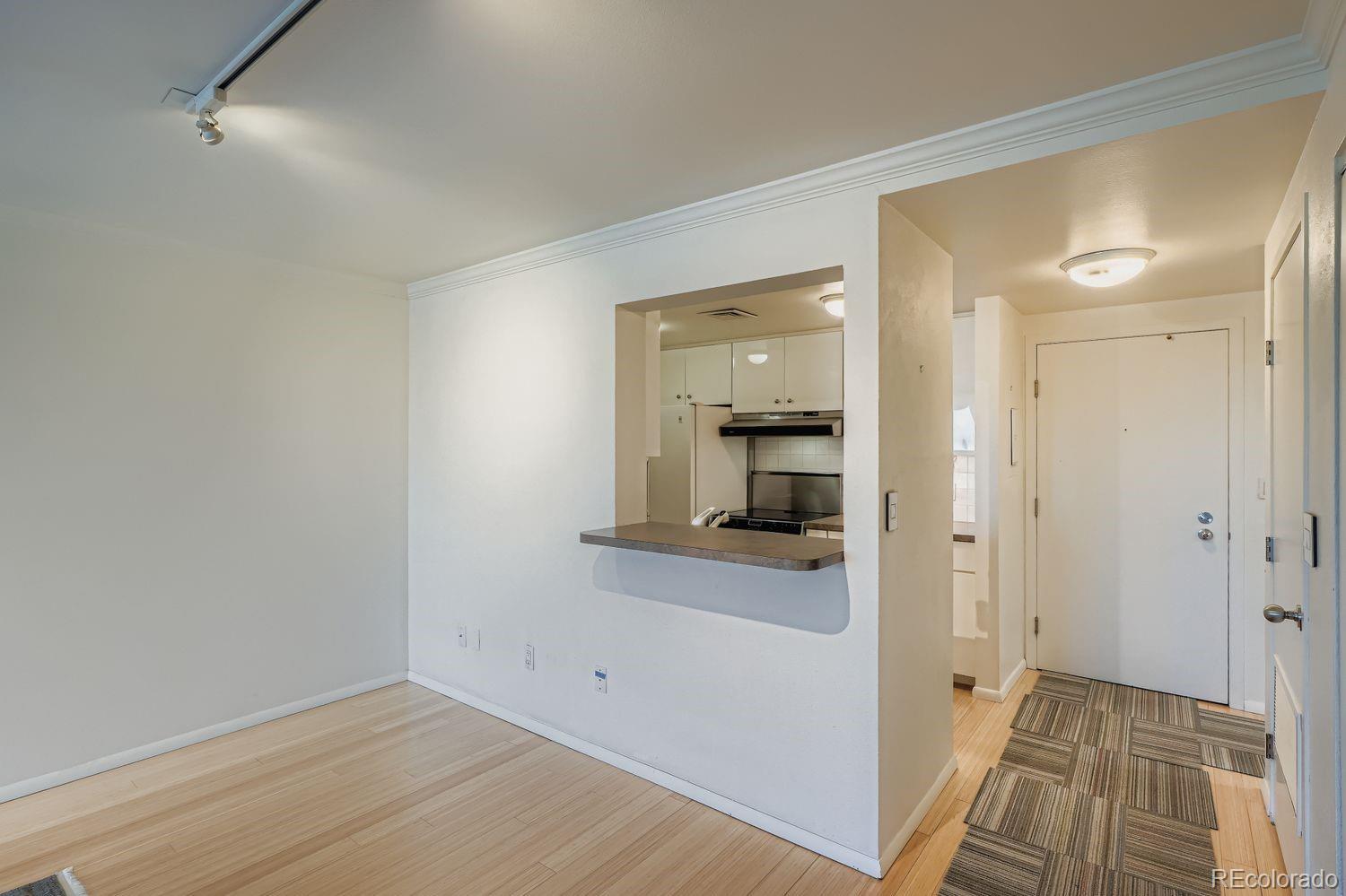 800 Pearl Street, Unit 809 Denver, CO 80203 - Photo 3 of 15 a view of a hallway with wooden floor and a bathroom