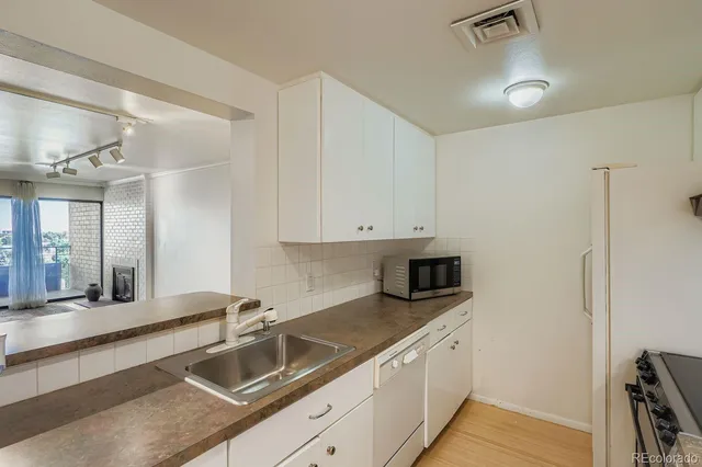 a kitchen with a sink cabinets and stainless steel appliances