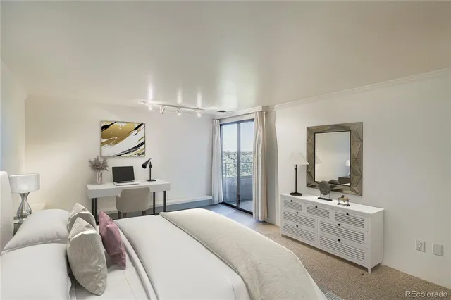 a bedroom with a bed and a large mirror