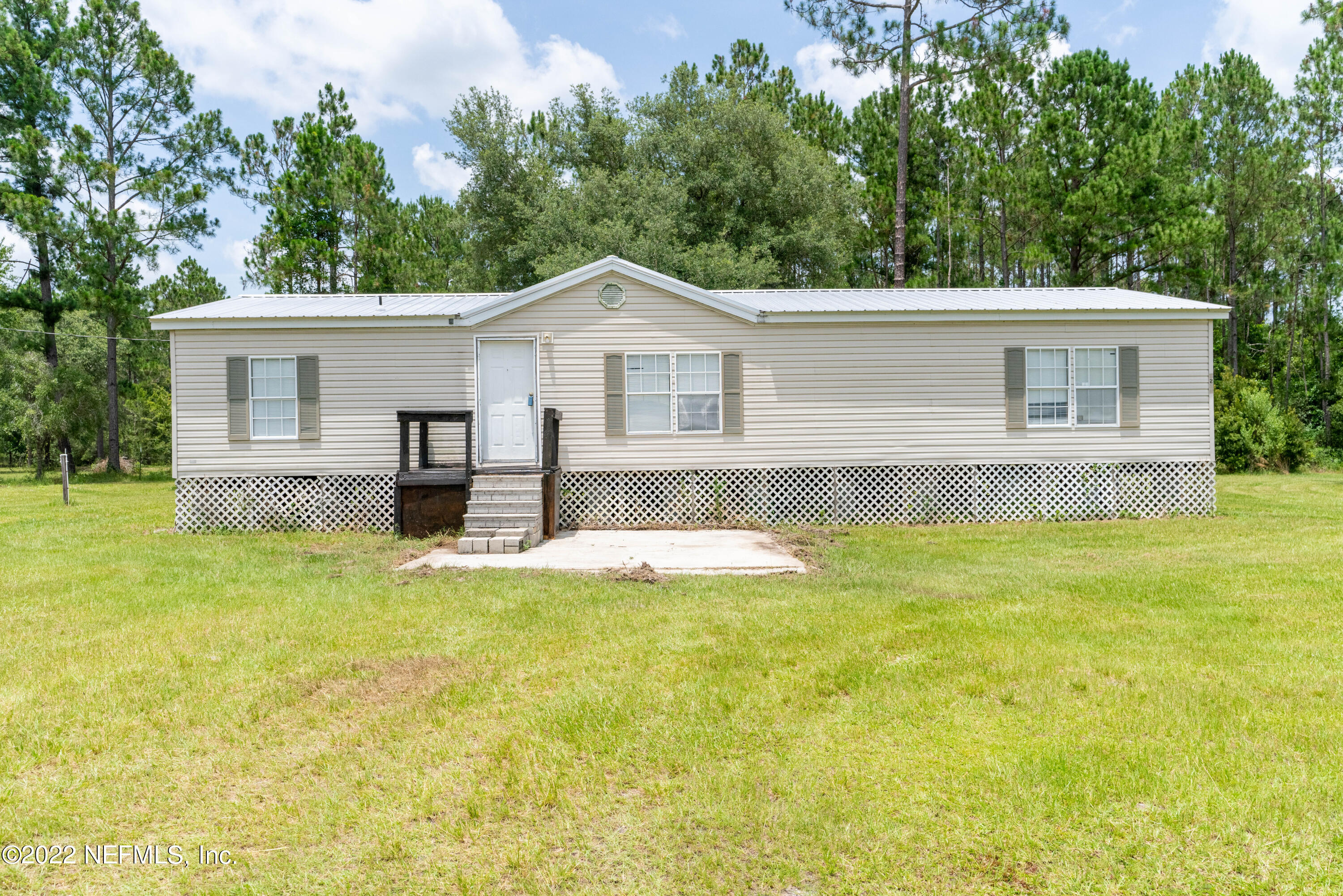 a view of a house with pool and a yard
