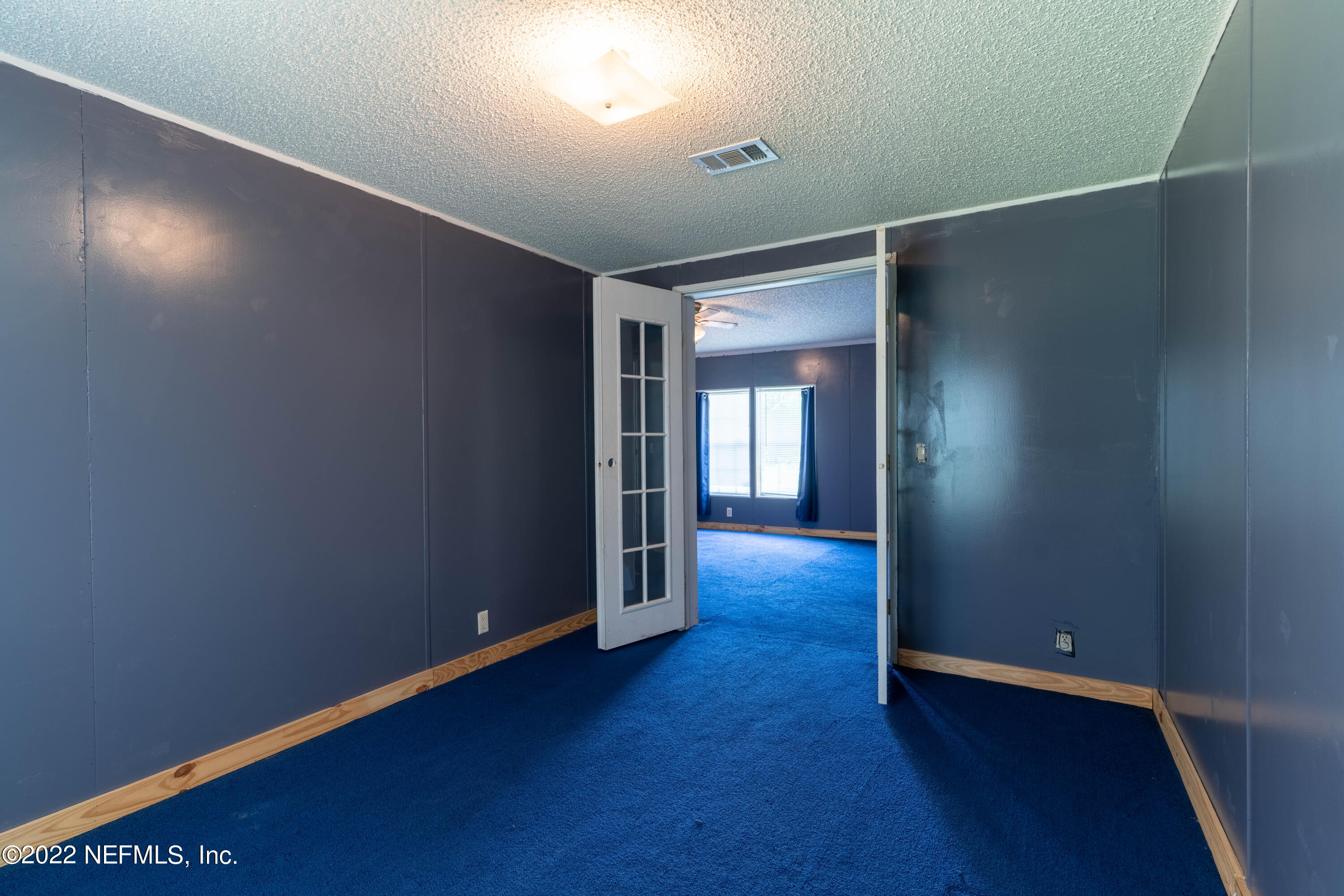 19697 Crews Road Glen St. Mary, FL 32040 - Photo 11 of 25 an empty room with wooden floor and windows