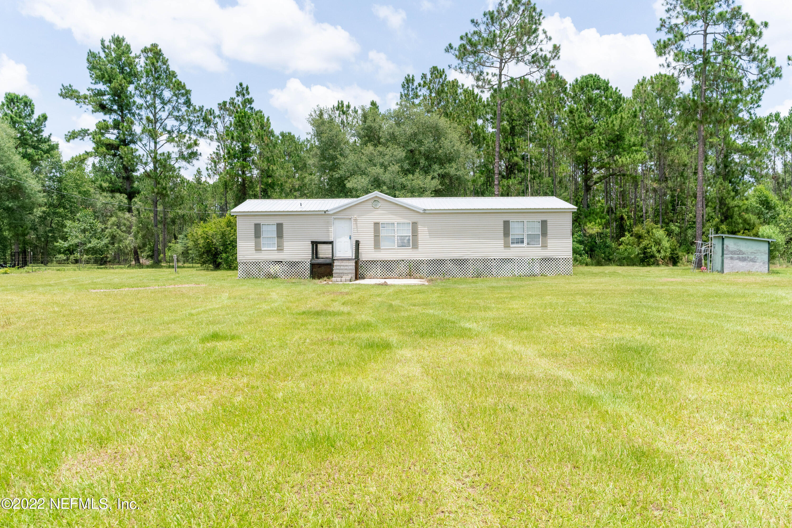 19697 Crews Road Glen St. Mary, FL 32040 - Photo 3 of 25 a view of house with yard and trees in the background
