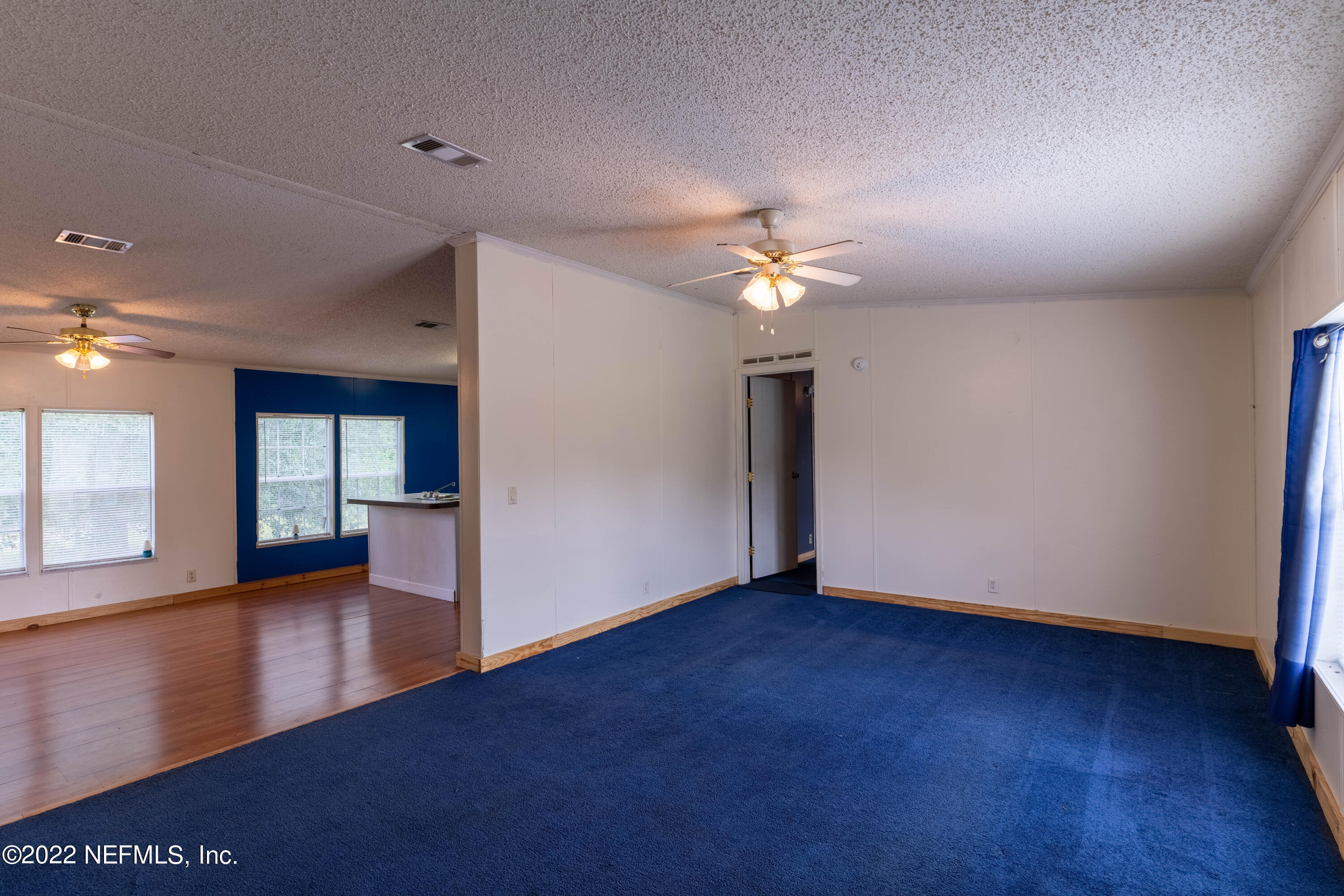 19697 Crews Road Glen St. Mary, FL 32040 - Photo 4 of 25 a view of an empty room with window and wooden floor