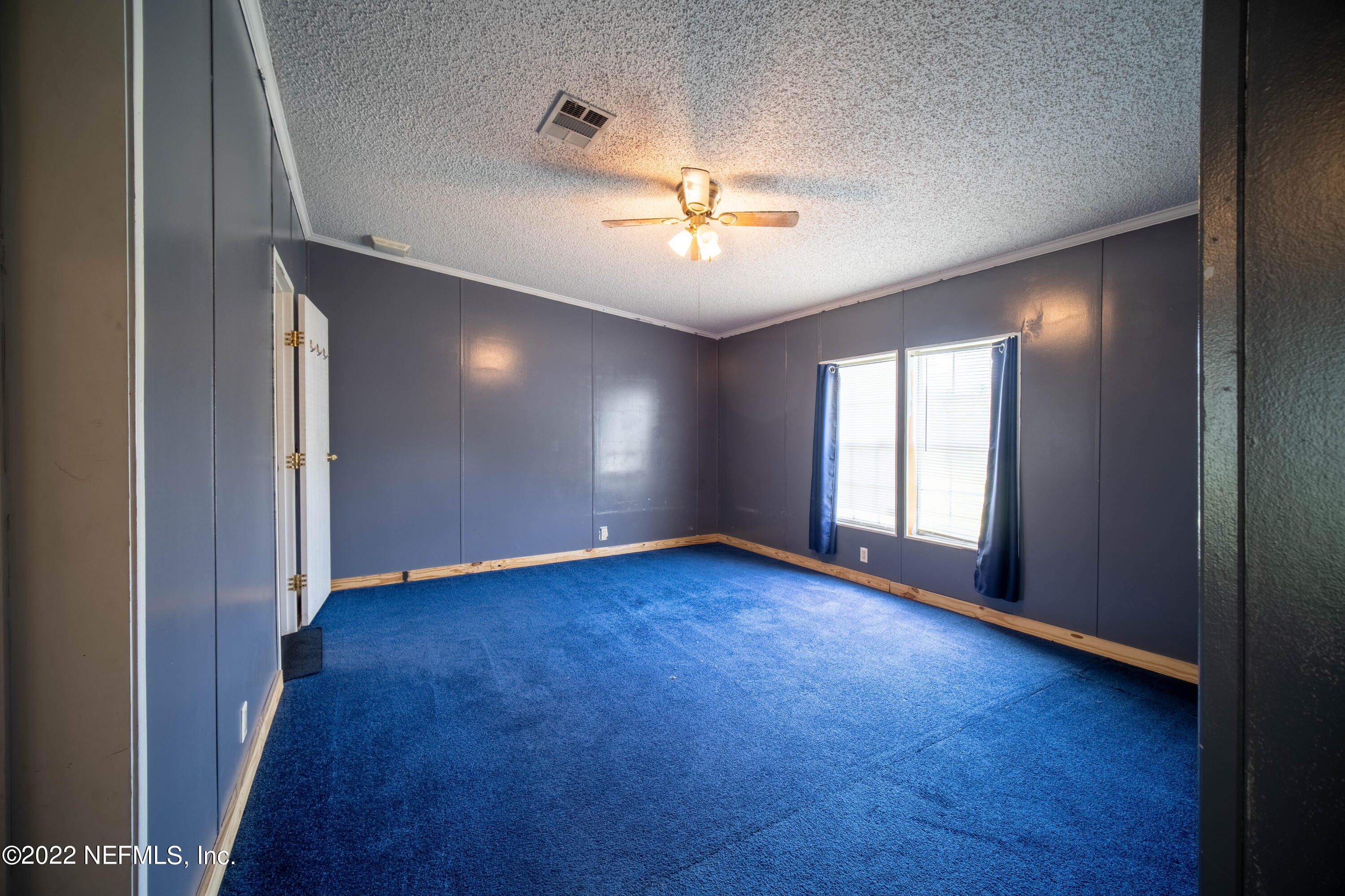 19697 Crews Road Glen St. Mary, FL 32040 - Photo 5 of 25 an empty room with windows and ceiling fan