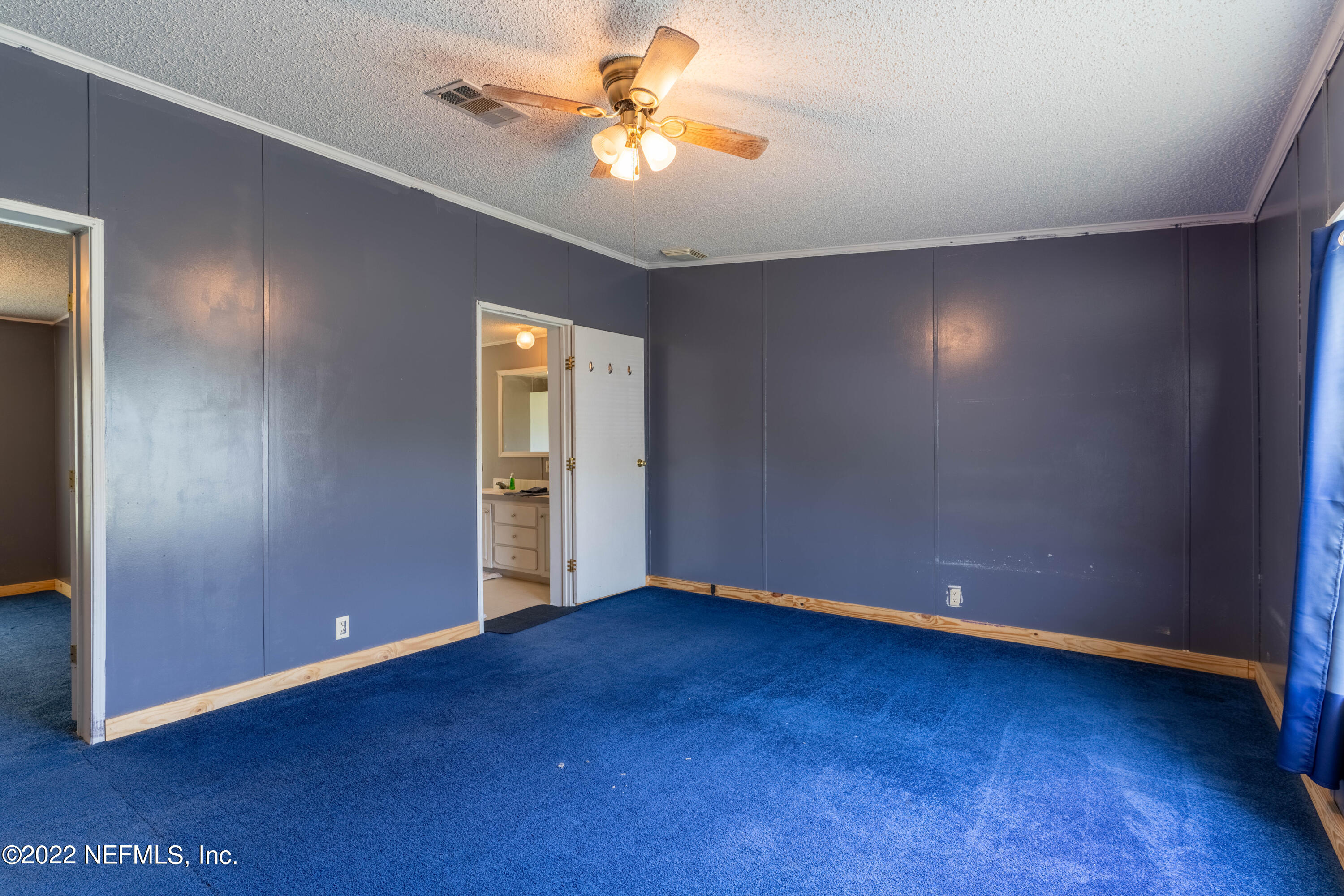 19697 Crews Road Glen St. Mary, FL 32040 - Photo 6 of 25 a view of an empty room with window and wooden floor