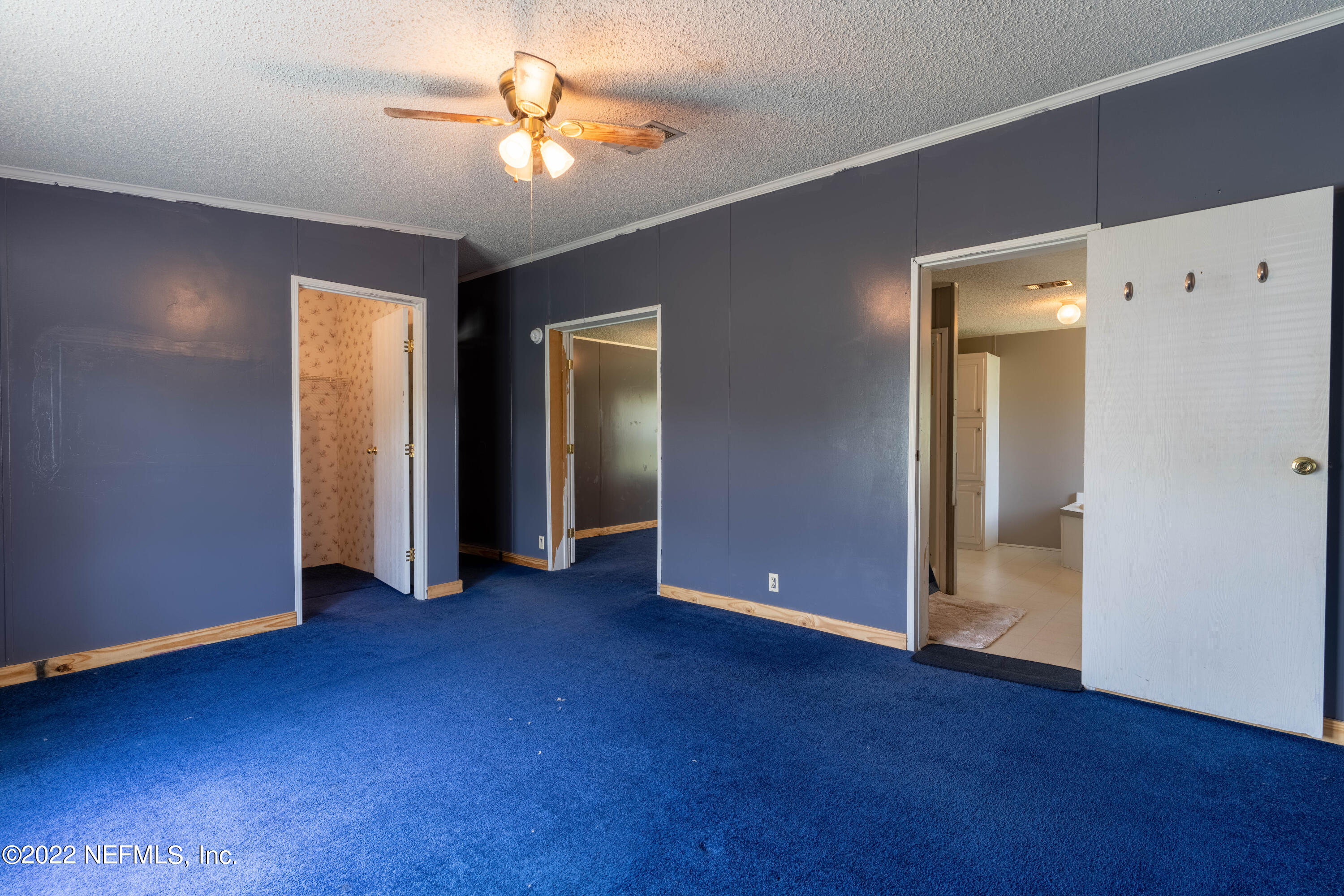19697 Crews Road Glen St. Mary, FL 32040 - Photo 7 of 25 an empty room with closet and a chandelier fan