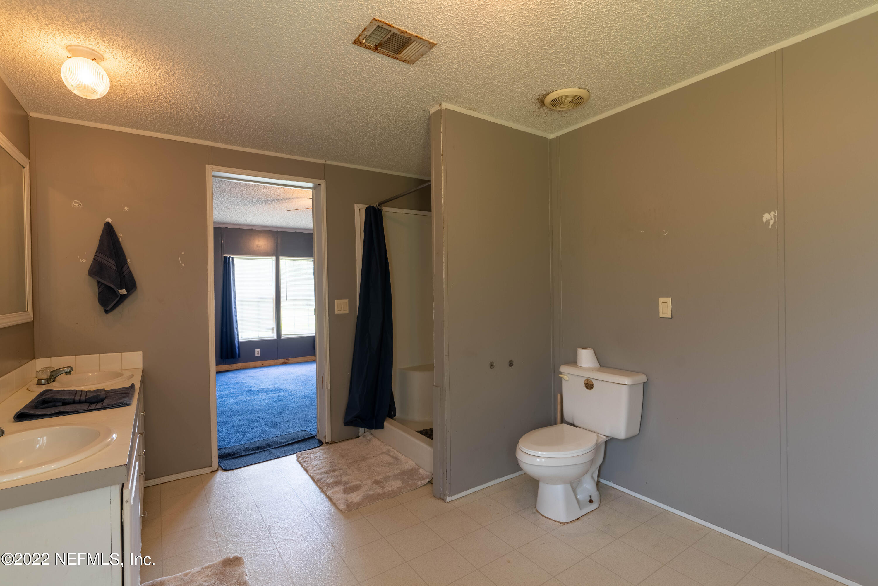 19697 Crews Road Glen St. Mary, FL 32040 - Photo 9 of 25 a bathroom with a toilet a sink and mirror
