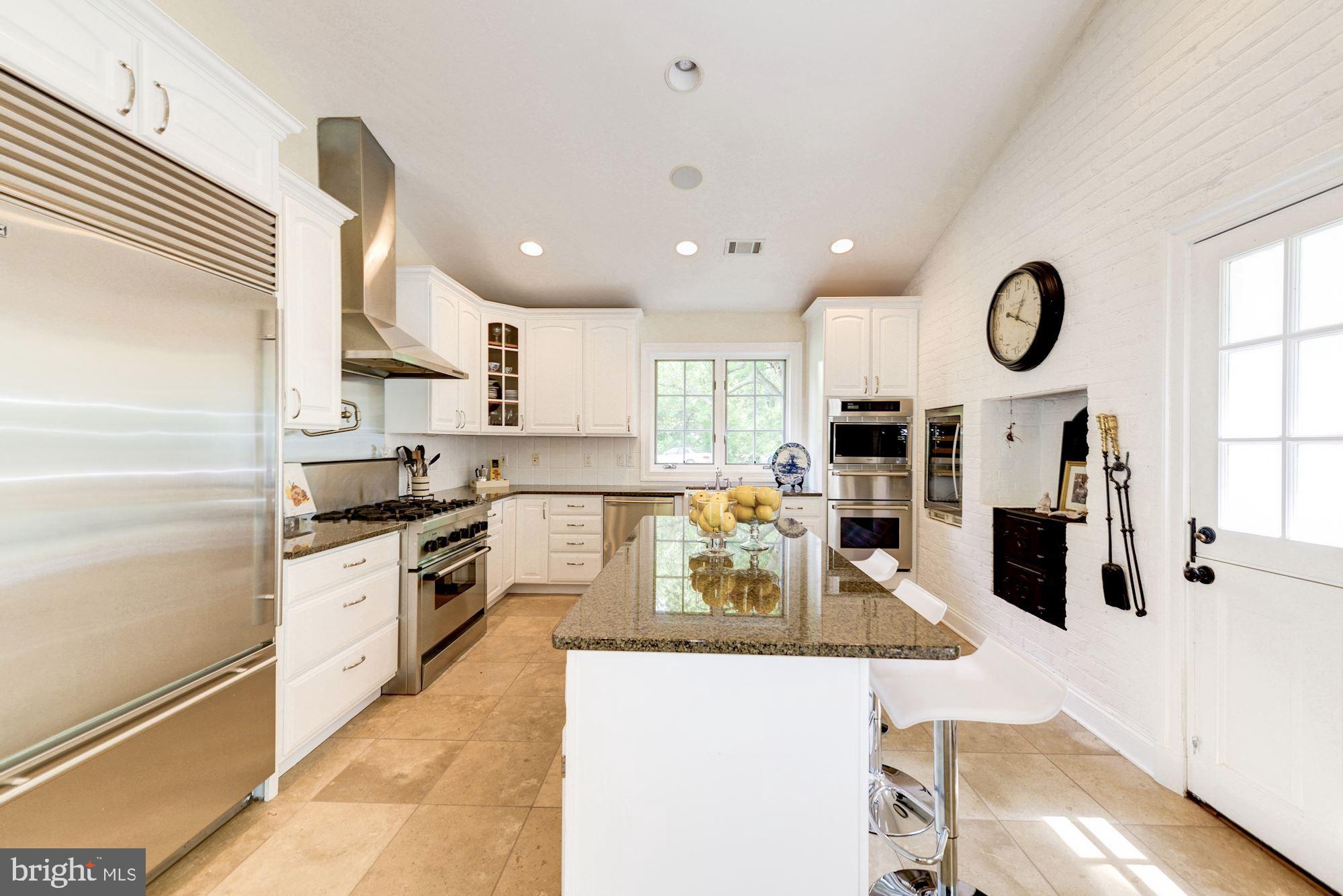 1018 Shipman Lane McLean, VA 22101 - Photo 12 of 30 a large kitchen with stainless steel appliances granite countertop a stove a sink a microwave and a refrigerator