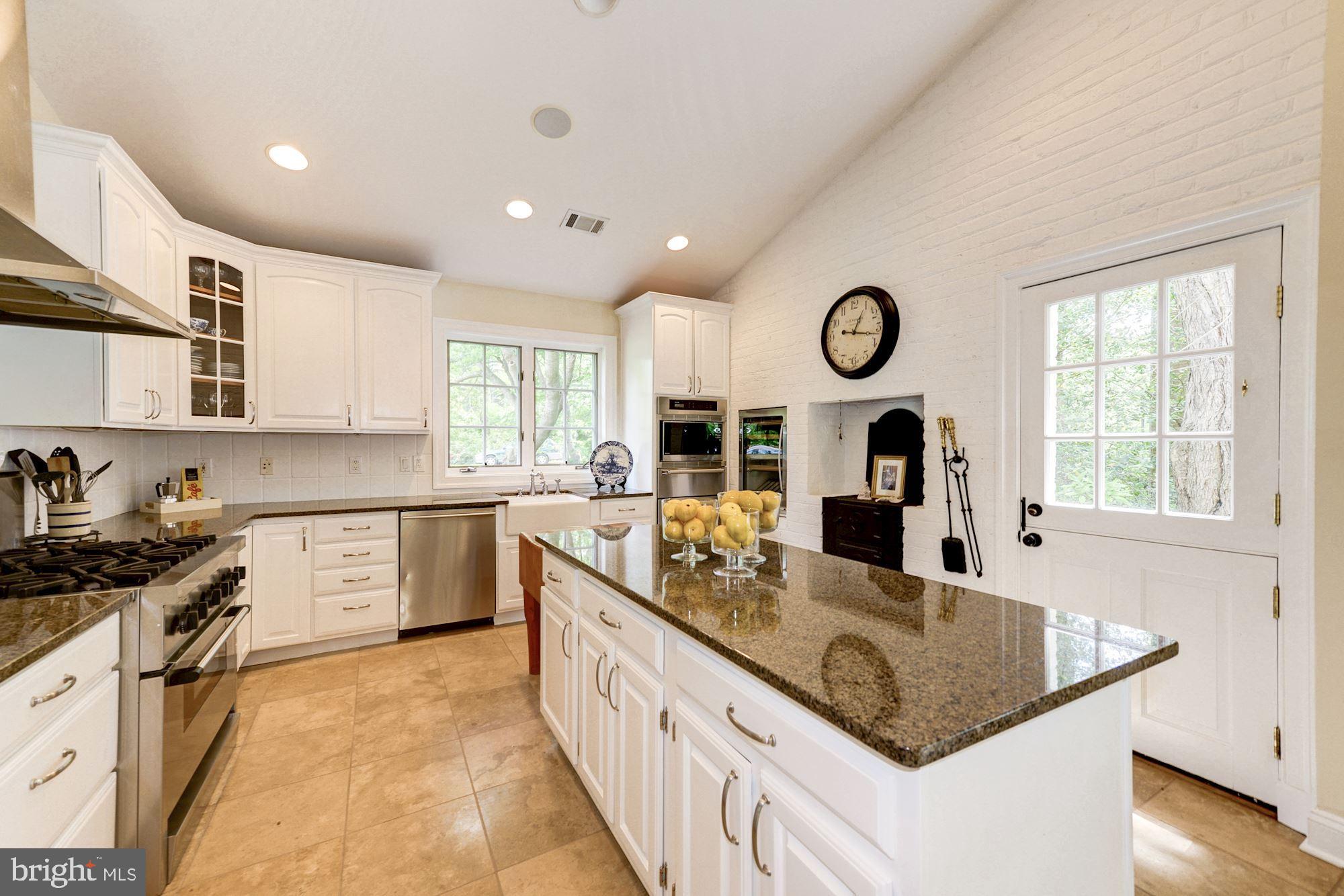 1018 Shipman Lane McLean, VA 22101 - Photo 9 of 30 a kitchen with stainless steel appliances granite countertop a sink stove and cabinets